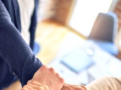 person in black long sleeve shirt holding persons hand